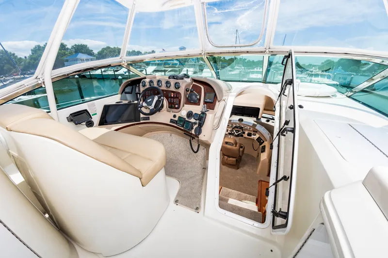 Slide: The Image of 2004 Carver 56 Voyager SE yacht helm with modern navigation equipment and panoramic windows. - 33