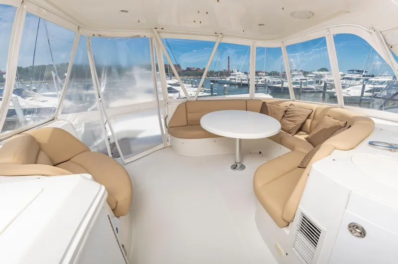 Slide: The Image of Luxurious interior of 2004 Carver 56 Voyager SE yacht with beige seating and round table. - 37