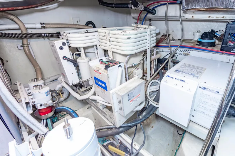 Slide: The Image of Engine room of a 2004 Carver 56 Voyager SE yacht with mechanical components. - 42