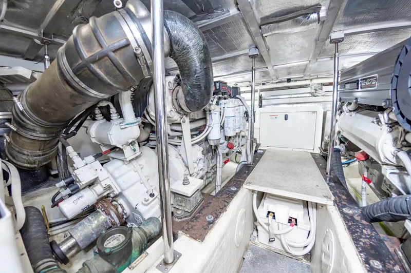 Slide: The Image of Engine room of a 2004 Carver 56 Voyager SE yacht, showcasing mechanical components. - 44