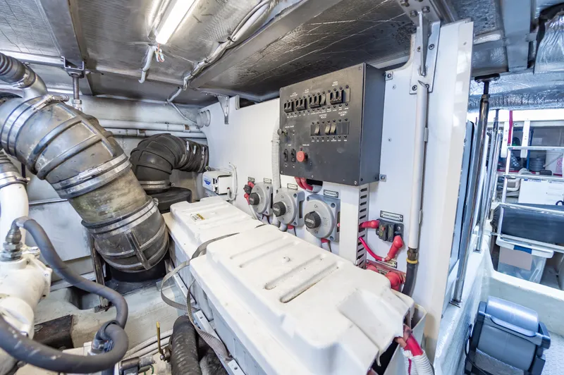 Slide: The Image of Engine room of a 2004 Carver 56 Voyager SE yacht with control panel and machinery. - 48