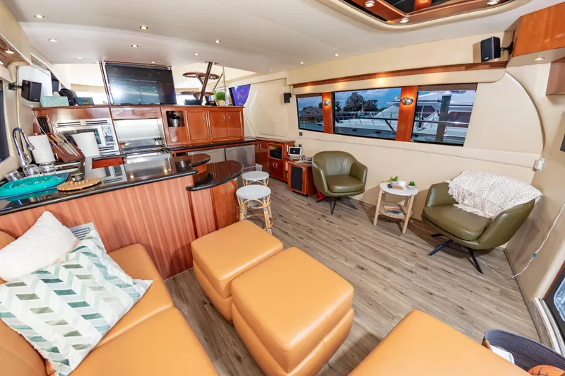 Slide: The Image of Luxurious interior of 2004 Carver 56 Voyager SE yacht with modern furnishings and large windows. - 5