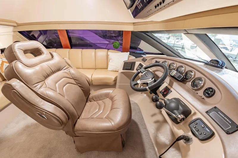 Slide: The Image of 2004 Carver 56 Voyager SE helm with leather captain's chair and navigation controls. - 8
