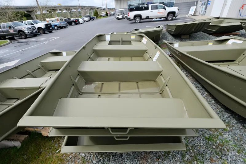 Slide: The Image of 2024 Crestliner 1040 CR Jon boat displayed in a dealership lot. - 2