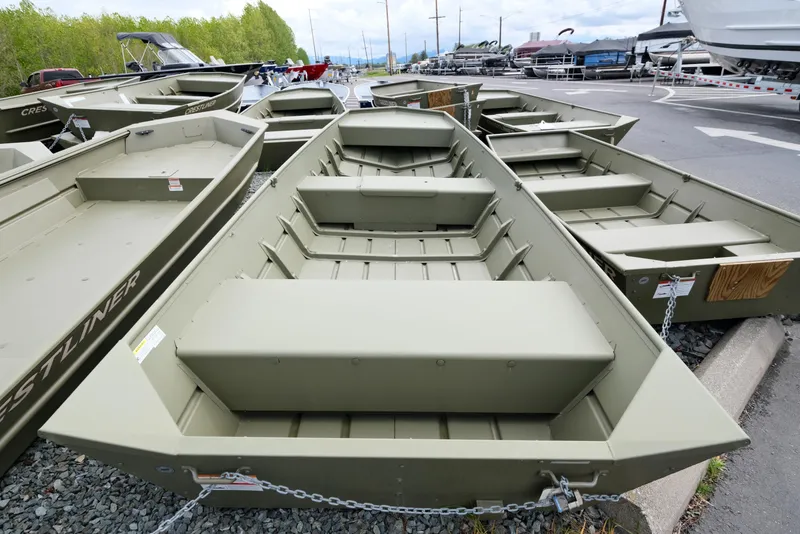 Slide: The Image of 2023 Crestliner 1648M CR Jon boats displayed at a dealership. - 2