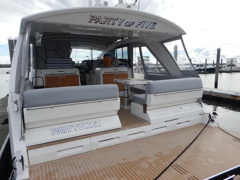 Slide: The Image of 2012 Sealine S450 yacht docked, named "Party of Five". - 10