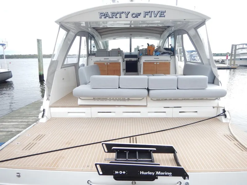 Slide: The Image of 2012 Sealine S450 yacht docked, featuring spacious deck. - 6