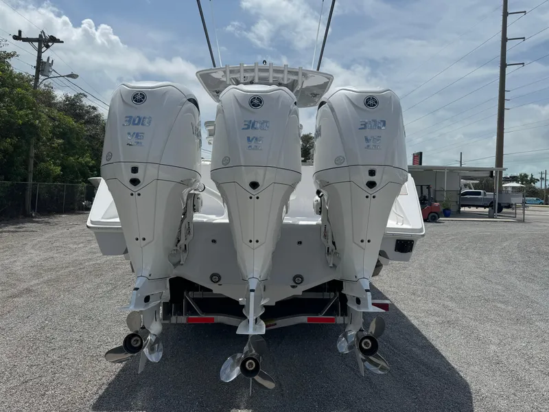 Slide: The Image of 2024 Jupiter 340LS boat with triple 300 HP outboard engines, rear view. - 1