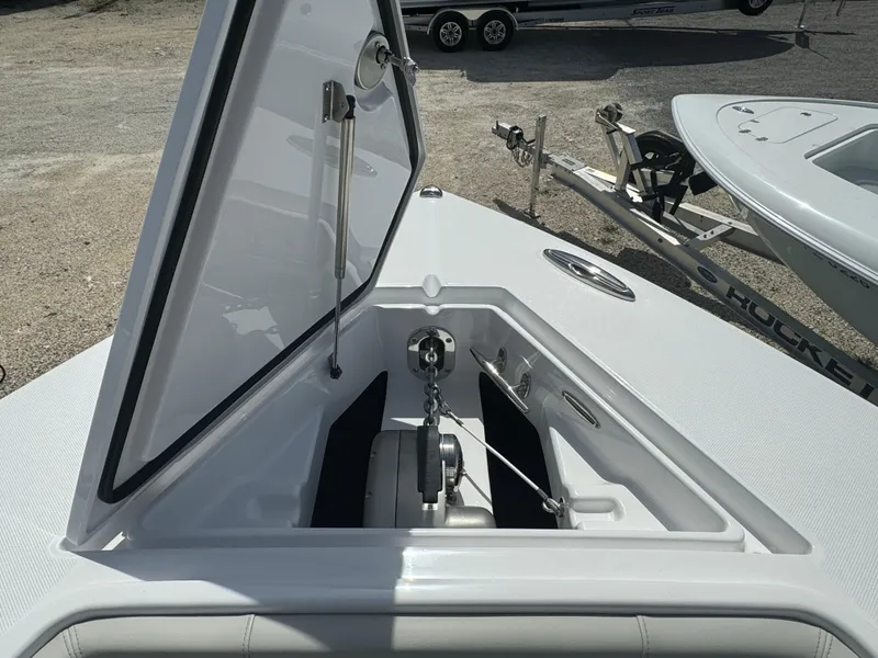 Slide: The Image of 2024 Jupiter 340LS boat anchor compartment with open hatch, showcasing storage and mechanism. - 10