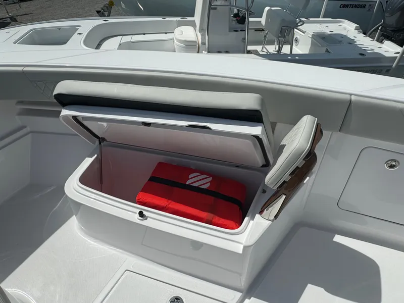 Slide: The Image of 2024 Jupiter 340LS boat with open storage compartment and red bag inside. - 11