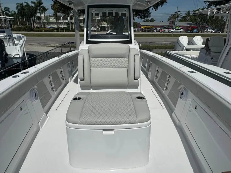 Slide: The Image of 2024 Jupiter 340LS boat interior with cushioned seating and storage compartments. - 12
