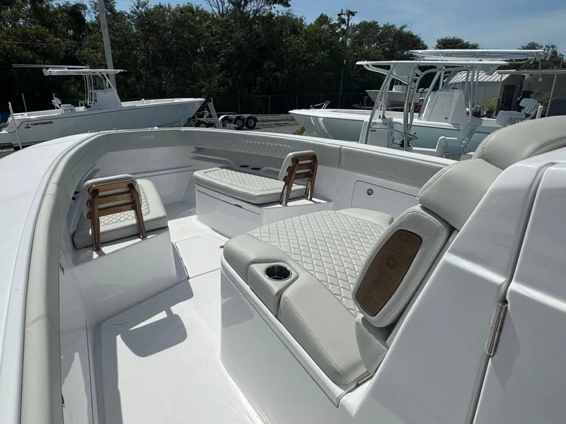 Slide: The Image of 2024 Jupiter 340LS boat interior with cushioned seating and modern design. - 9