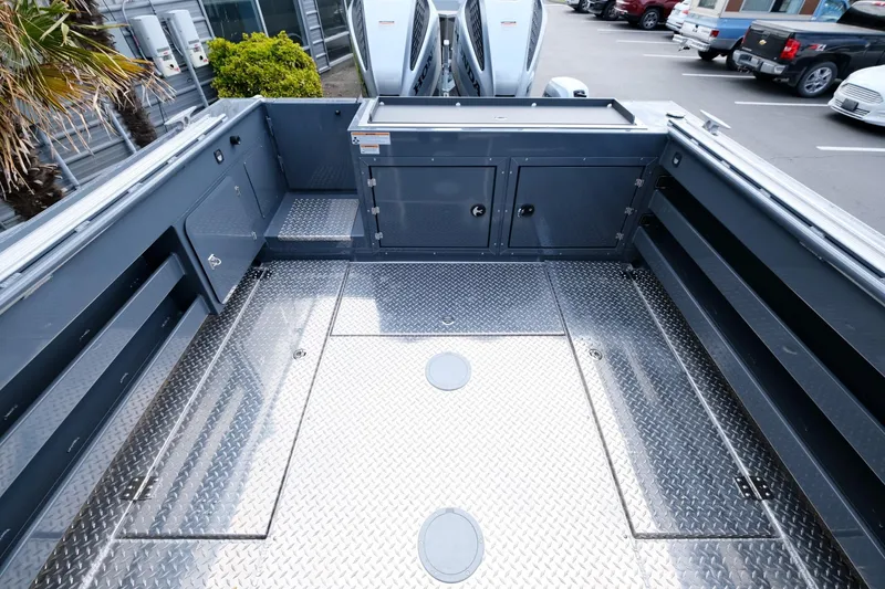 Slide: The Image of 2024 Hewescraft 250 Explorer boat deck with storage compartments and diamond plate flooring. - 8