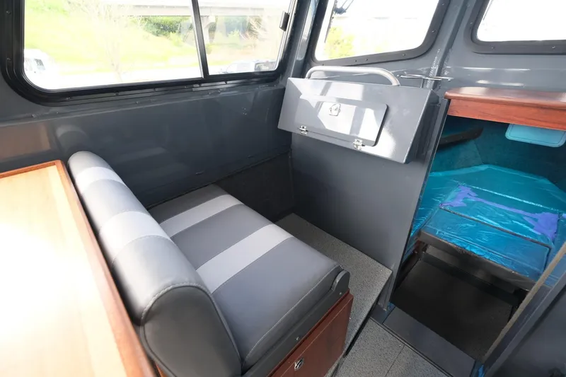 Slide: The Image of 2024 Hewescraft 250 Explorer interior with seating and storage. - 16