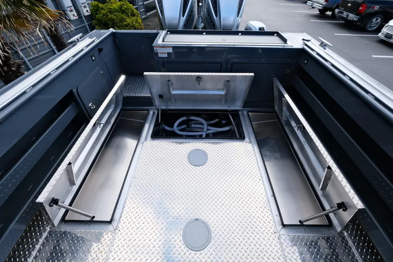 Slide: The Image of 2024 Hewescraft 250 Explorer boat interior with storage compartments and diamond plate flooring. - 20