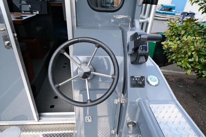 Slide: The Image of 2024 Hewescraft 250 Explorer steering wheel and controls, showcasing modern design and functionality. - 9