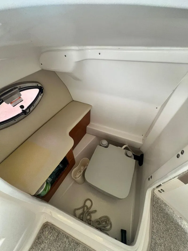 Slide: The Image of Interior cabin of a 2013 Chaparral 244 Sunesta boat with seating and storage. - 15