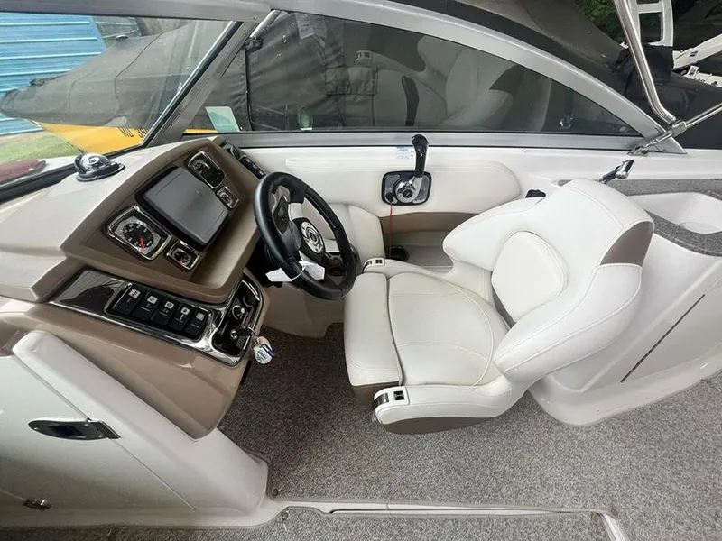 Slide: The Image of 2013 Chaparral 244 Sunesta boat cockpit with steering wheel and captain's chair. - 16