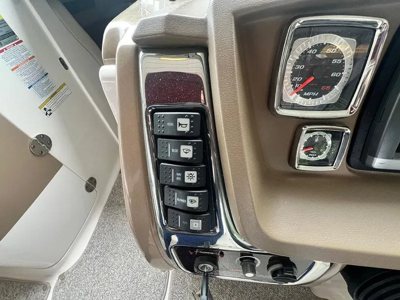Slide: The Image of 2013 Chaparral 244 Sunesta boat dashboard with control switches and speedometer. - 18