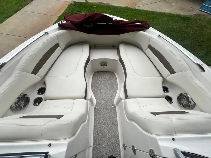 Slide: The Image of 2013 Chaparral 244 Sunesta boat interior with white seating and cup holders. - 22