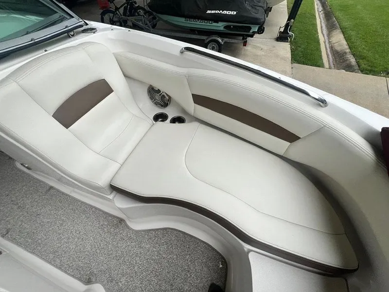 Slide: The Image of 2013 Chaparral 244 Sunesta boat interior seating area with cup holders. - 23
