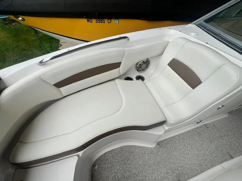 Slide: The Image of 2013 Chaparral 244 Sunesta boat interior with white and brown seating. - 24