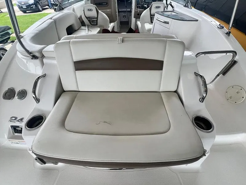 Slide: The Image of 2013 Chaparral 244 Sunesta boat interior with white and brown seating. - 7