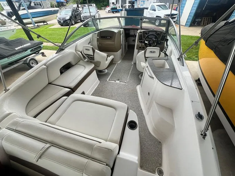 Slide: The Image of 2013 Chaparral 244 Sunesta boat interior with spacious seating and modern dashboard. - 8