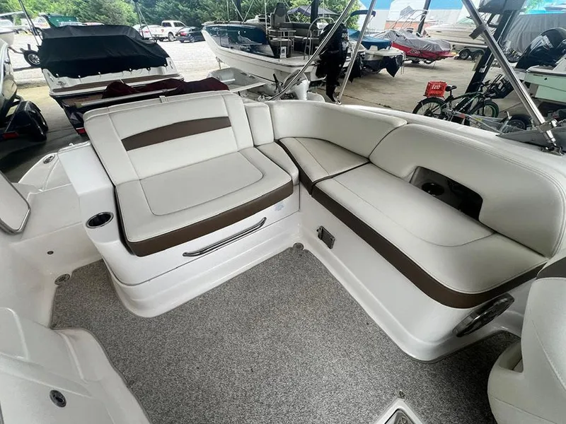 Slide: The Image of 2013 Chaparral 244 Sunesta boat interior with white and brown seating. - 9