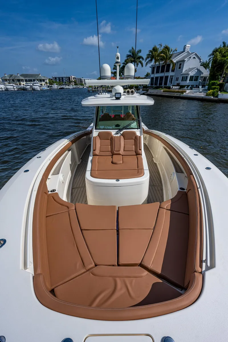 Slide: The Image of 2017 Scout 420 LXF boat with luxurious brown seating on a sunny day. - 13