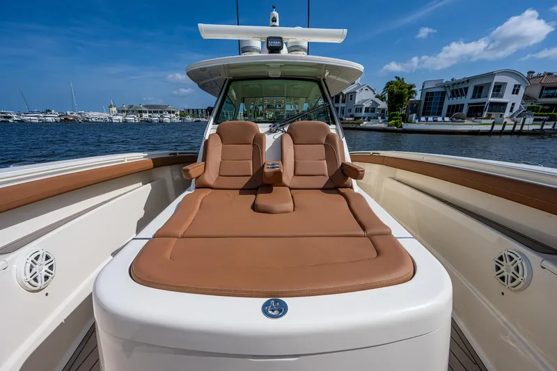 Slide: The Image of 2017 Scout 420 LXF boat with luxurious seating on a sunny day. - 15