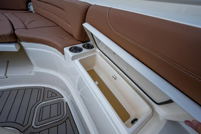Slide: The Image of 2017 Scout 420 LXF boat interior with storage compartment and cup holders. - 17