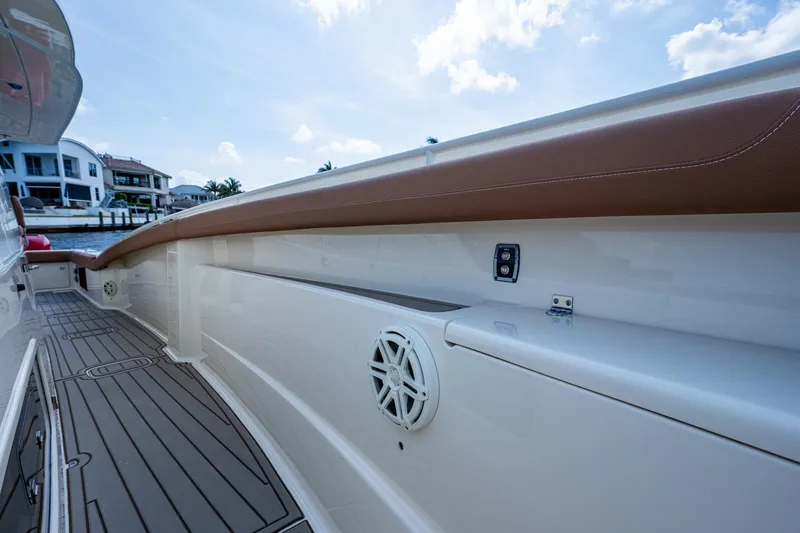 Slide: The Image of 2017 Scout 420 LXF boat deck with speaker and brown trim. - 18