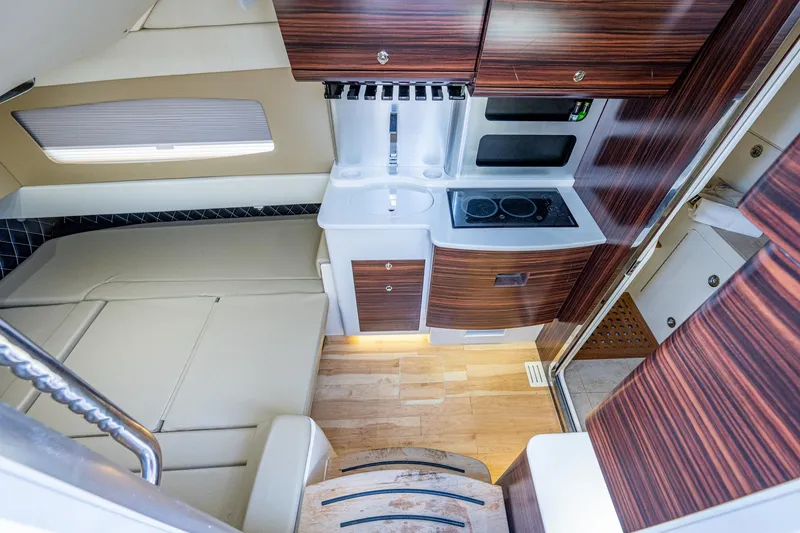 Slide: The Image of 2017 Scout 420 LXF cabin interior with kitchenette and wooden cabinetry. - 19