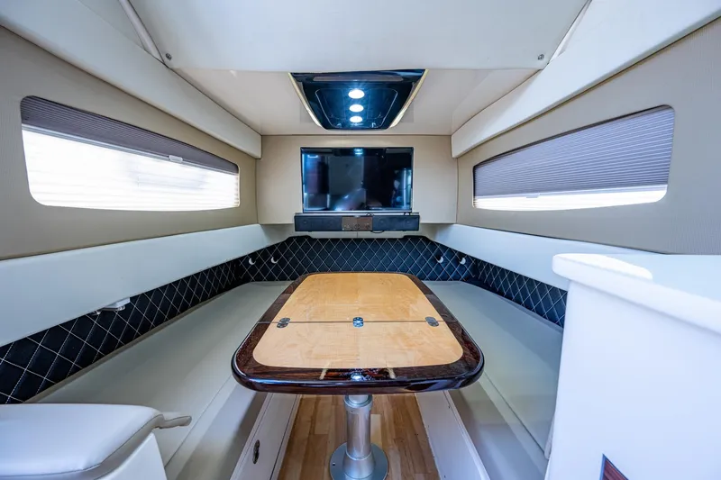 Slide: The Image of 2017 Scout 420 LXF cabin interior with table and TV. - 20