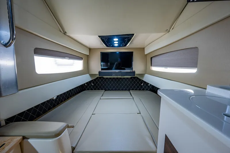 Slide: The Image of Luxurious interior cabin of a 2017 Scout 420 LXF boat with TV and seating. - 21