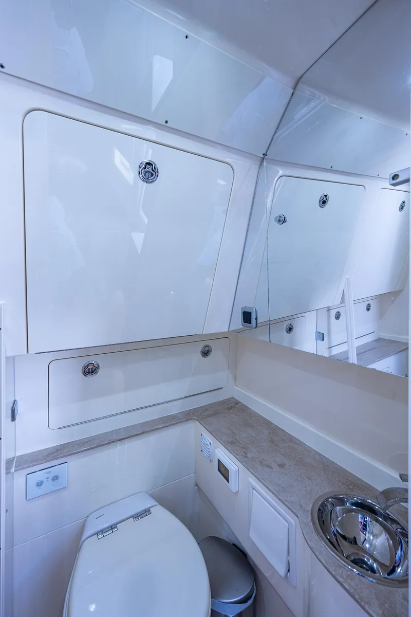 Slide: The Image of 2017 Scout 420 LXF boat bathroom with modern fixtures and ample storage. - 26