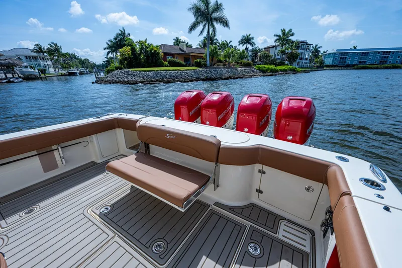 Slide: The Image of 2017 Scout 420 LXF boat with four red outboard engines on a sunny day. - 29