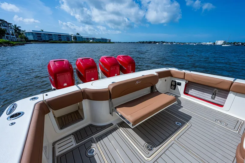 Slide: The Image of 2017 Scout 420 LXF boat with red engines on a sunny day. - 31