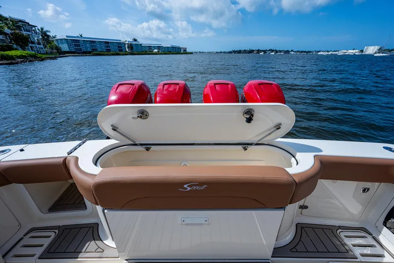 Slide: The Image of 2017 Scout 420 LXF boat with open storage compartment and scenic water view. - 35