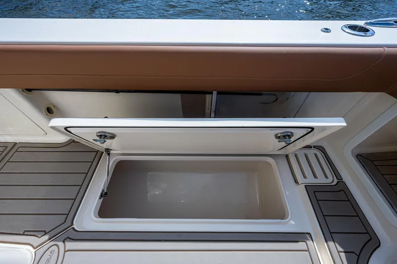 Slide: The Image of 2017 Scout 420 LXF boat storage compartment with open lid. - 36