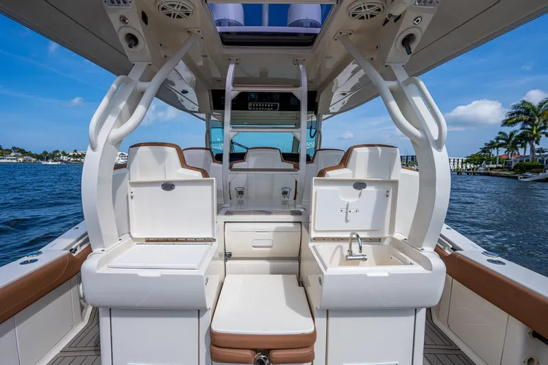 Slide: The Image of 2017 Scout 420 LXF boat interior with seating, storage, and sink. - 39