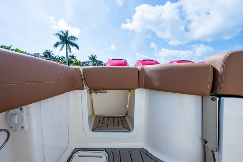 Slide: The Image of 2017 Scout 420 LXF boat interior with brown seating and open hatch. - 46