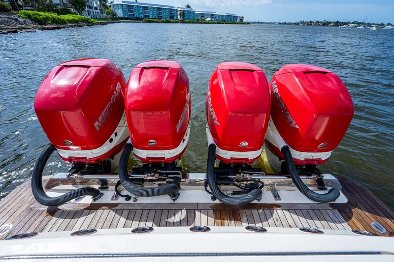 Slide: The Image of 2017 Scout 420 LXF with four red Mercury outboard engines on a wooden deck. - 48