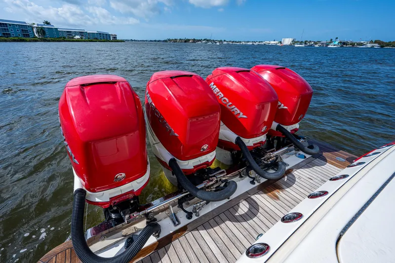 Slide: The Image of 2017 Scout 420 LXF with four red Mercury outboard engines on the water. - 49