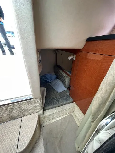 Slide: The Image of Interior cabin of 2004 Sea Ray 280 Sundancer with bed and wooden cabinetry. - 6
