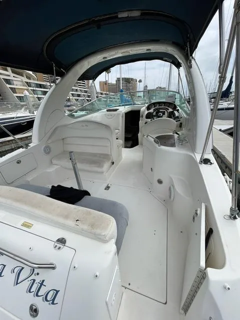 Slide: The Image of 2004 Sea Ray 280 Sundancer boat interior with seating and helm station. - 11