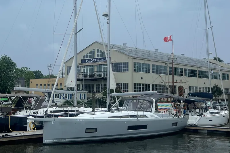 Slide: The Image of Beneteau Oceanis 46.1 2020 sailboat docked at marina with Canadian flag. - 2
