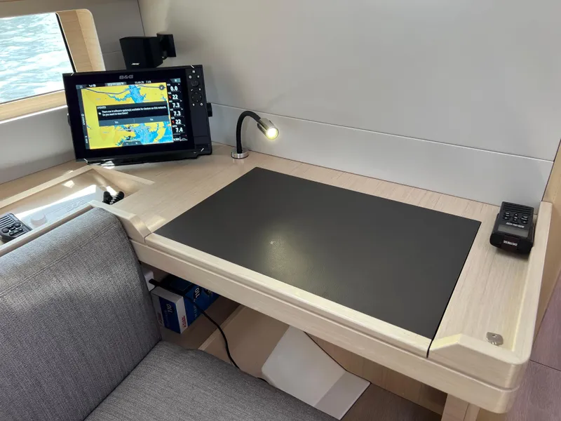 Slide: The Image of Navigation station on 2020 Beneteau Oceanis 46.1 yacht with chart plotter and desk lamp. - 20