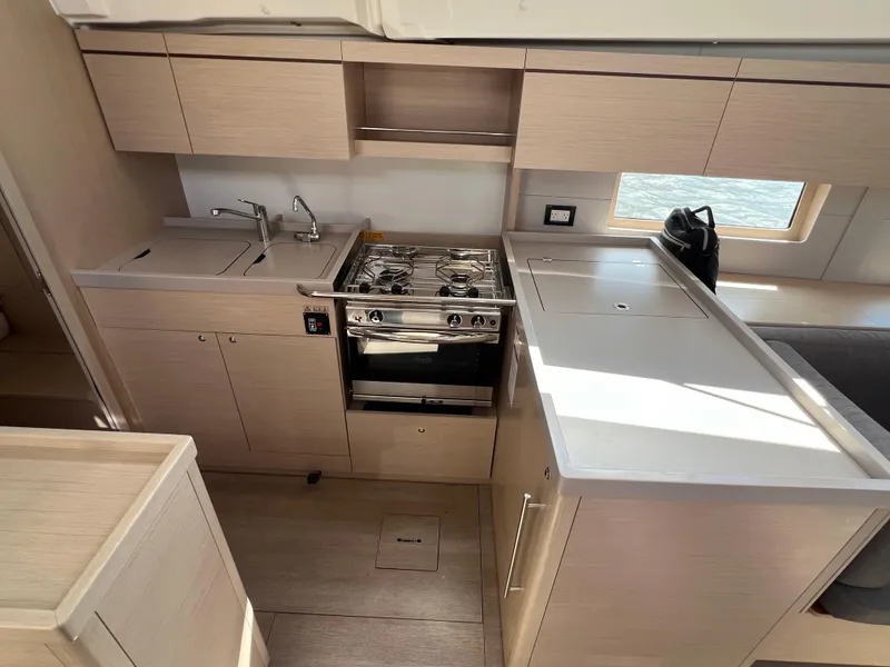 Slide: The Image of Modern kitchen interior of 2020 Beneteau Oceanis 46.1 yacht with stove and cabinetry. - 21